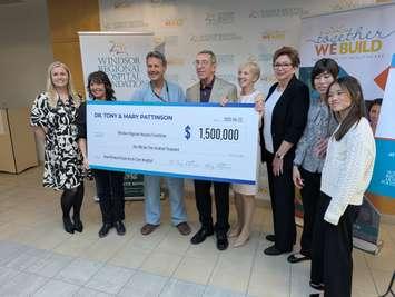 Doctor Tony Pattinson, fourth from left, and Mary Pattinson, fifth from left, present a cheque to the Windsor Regional Hospital Foundation, April 22, 2025. Photo by Mark Brown/WindsorNewsToday.ca.